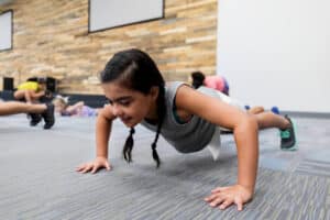 young student completing a push up assessment in PE class