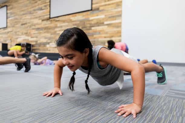 young student completing a push up assessment in PE class